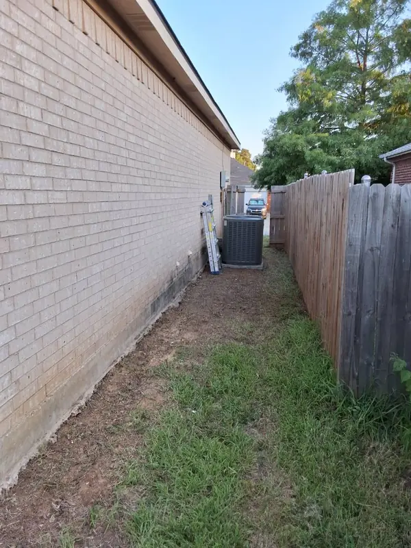 Same side yard cleared down to bare dirt after brush removal